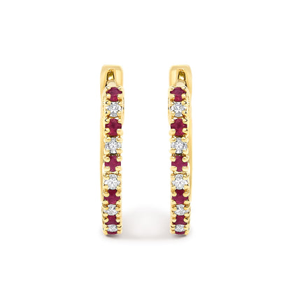 Front-facing close-up of yellow metal hoop earrings adorned with alternating round white and red gemstones in prong settings.