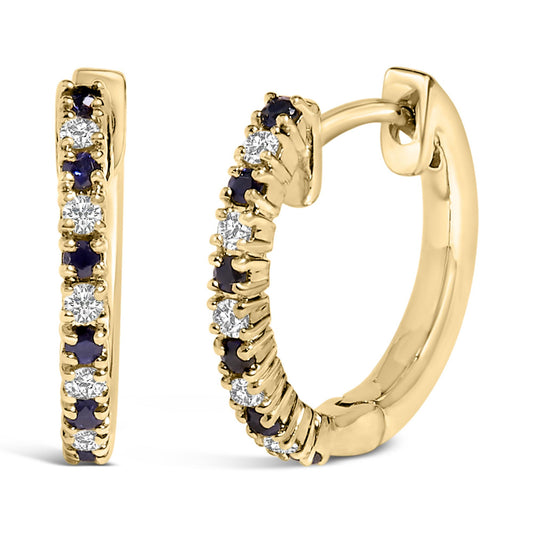 Close-up front and side view of a pair of yellow metal hoop earrings set with alternating round white and blue gemstones in prong settings.