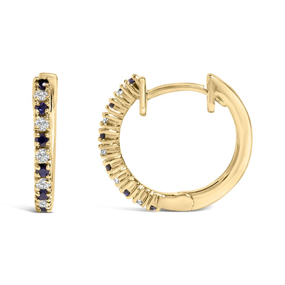 Pair of yellow metal hoop earrings with alternating white gemstones and blue gemstones set in prong settings, shown in a close-up front and side view on a white background.