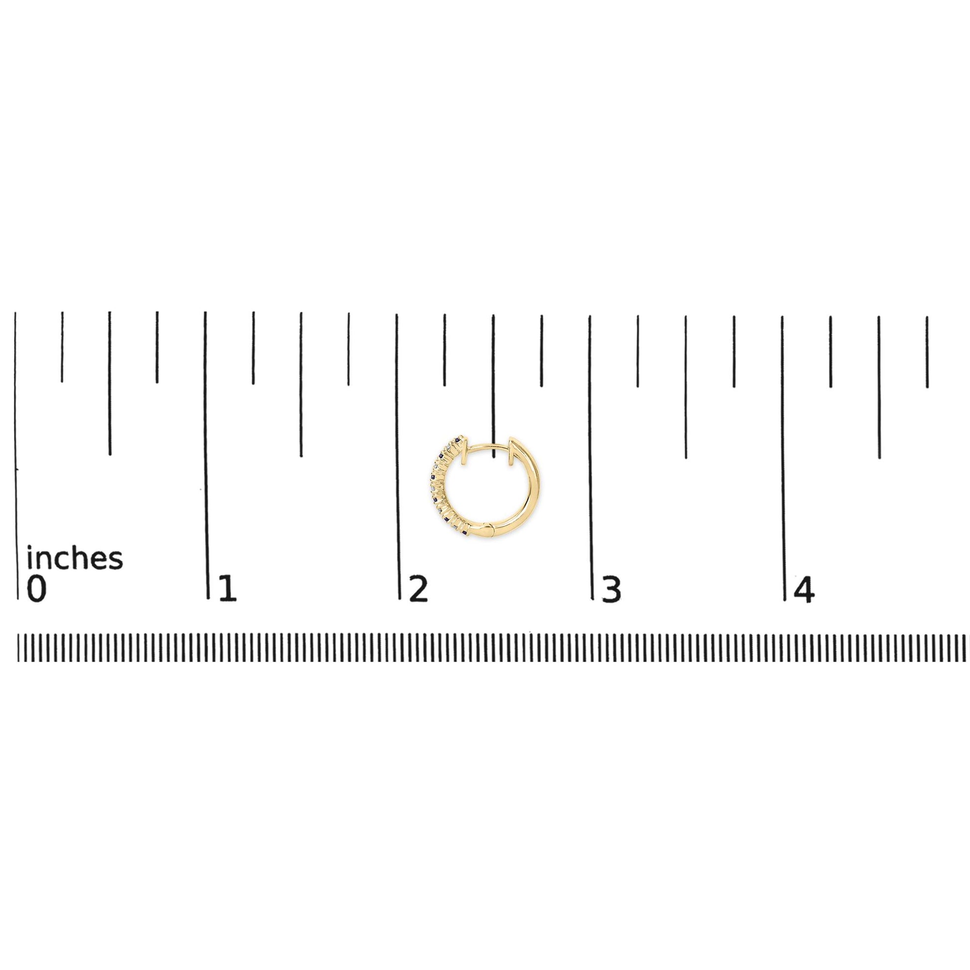 Yellow metal hoop earring with prong-set white and blue round gemstones, shown on a ruler scale from top view.
