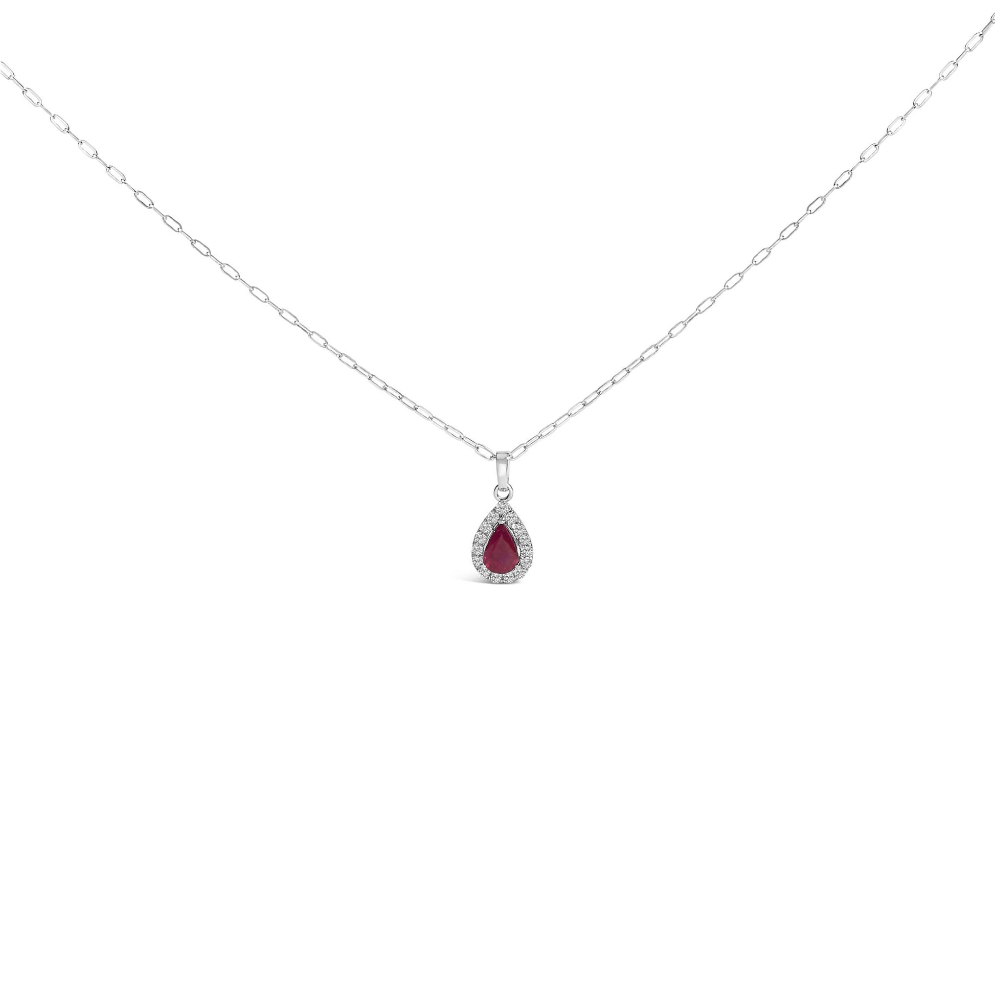 Front view of a white metal necklace with a pear-shaped red gemstone pendant surrounded by round white gemstones in a micro-pave setting, shown on a white background.