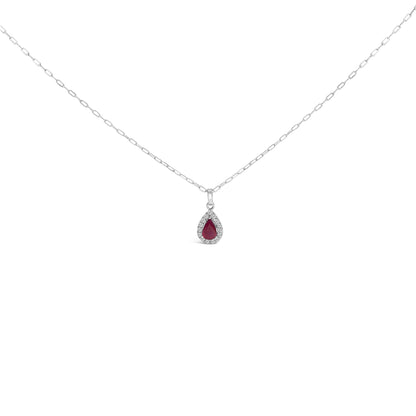Front view of a white metal necklace with a pear-shaped red gemstone pendant surrounded by round white gemstones in a micro-pave setting, shown on a white background.