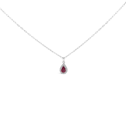 Front view of a white metal necklace with a pear-shaped red gemstone pendant surrounded by round white gemstones in a micro-pave setting, shown on a white background.