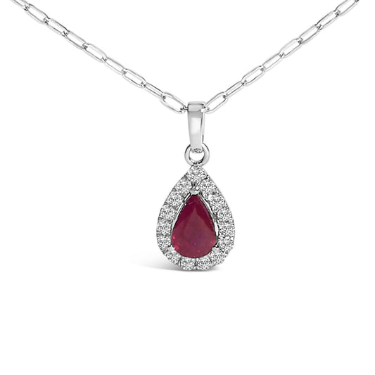 Close-up front view of a white metal necklace with a pear-shaped red gemstone pendant surrounded by a halo of round white gemstones in micro-pave setting.