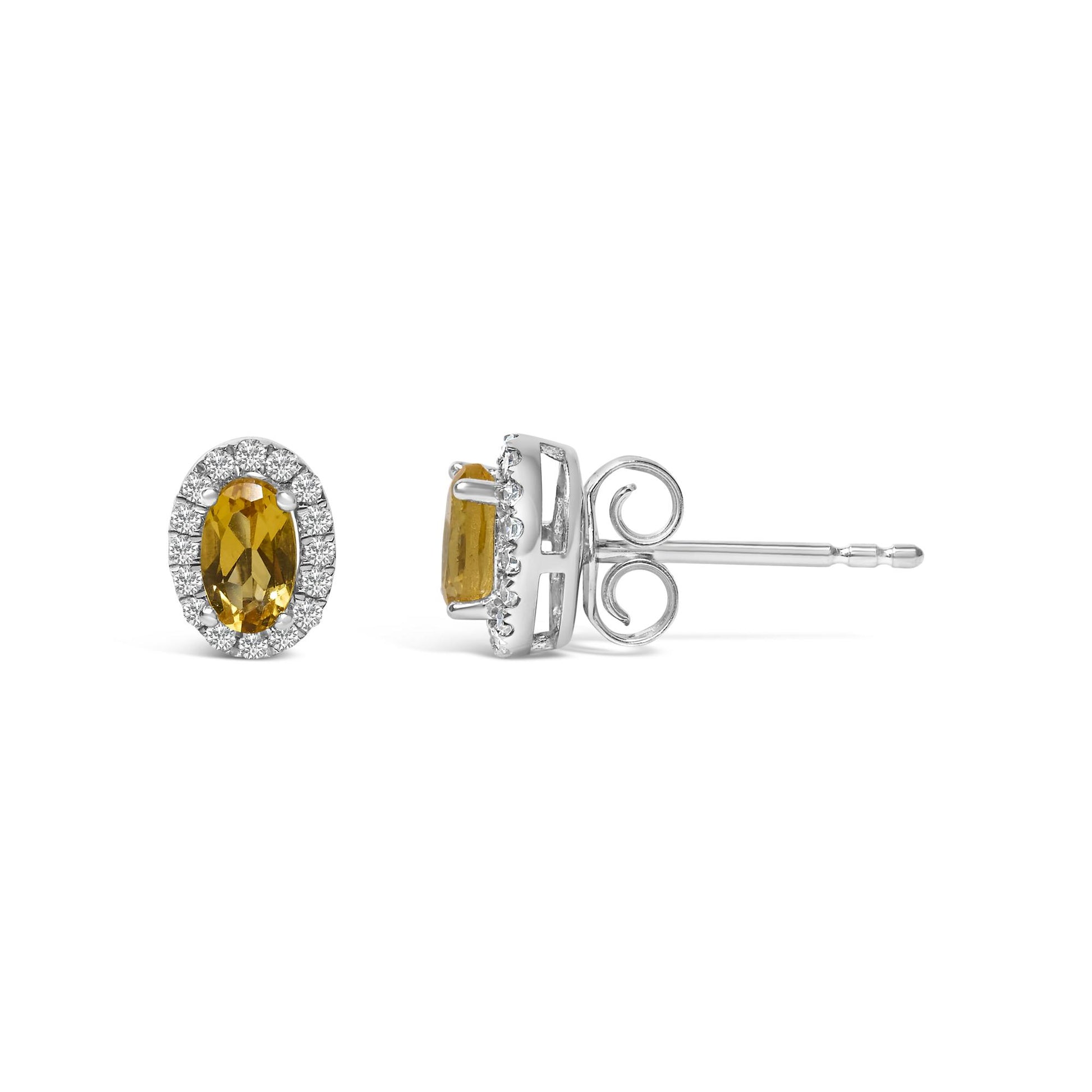 Front and side view of white metal stud earrings with oval yellow gemstones surrounded by white round pave-set gemstones, shown on a white background.