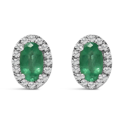Front view of white metal oval earrings featuring a green oval gemstone surrounded by a halo of round white gemstones in pave setting.
