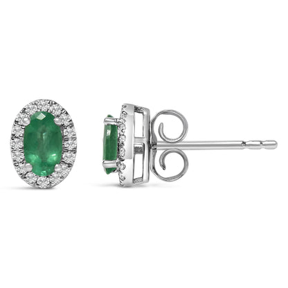 Pair of white metal stud earrings with oval green gemstones in center, surrounded by round white gemstones in pave setting, shown from front and side angles.