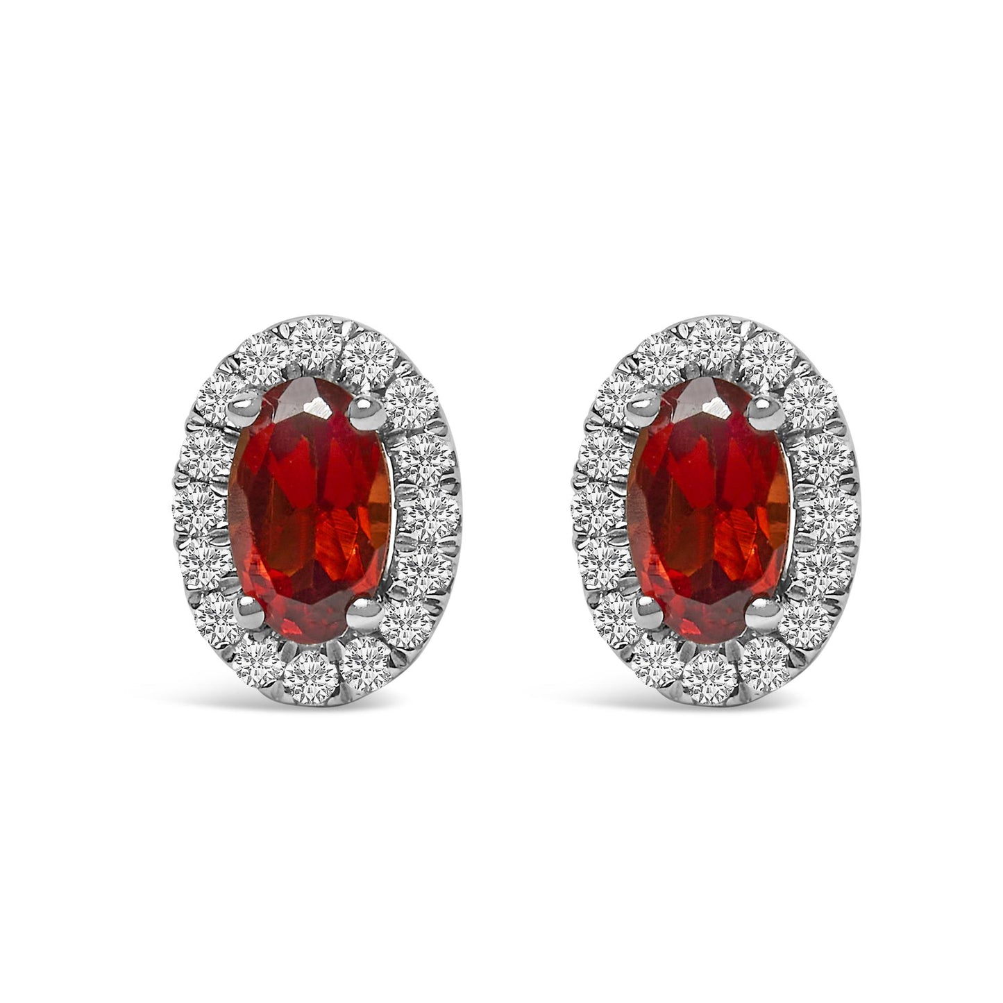 Front view of white metal oval earrings featuring a red oval gemstone center surrounded by a halo of small round white gemstones in pave setting.