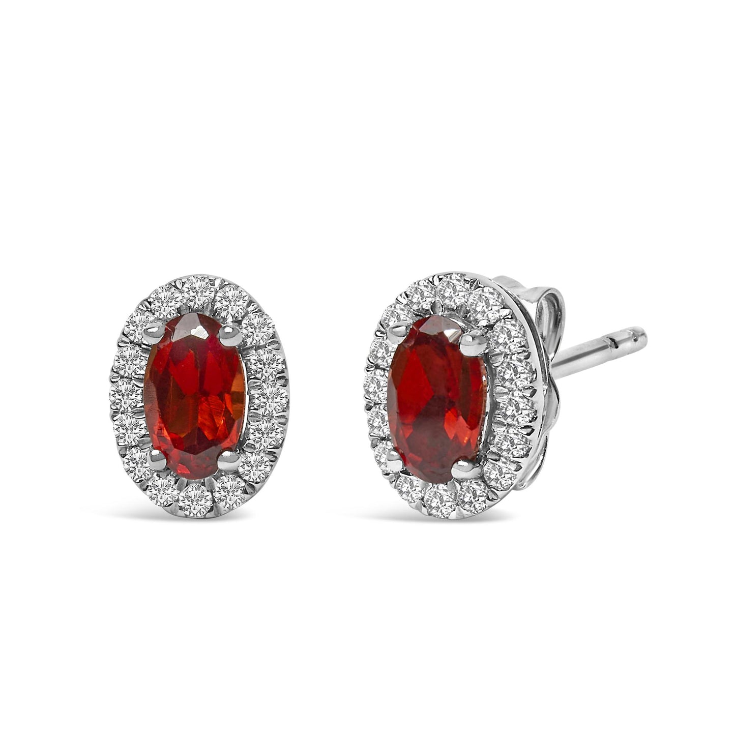 Pair of white metal stud earrings with red oval gemstones surrounded by a border of small white round gemstones, shown from a front and side angle.