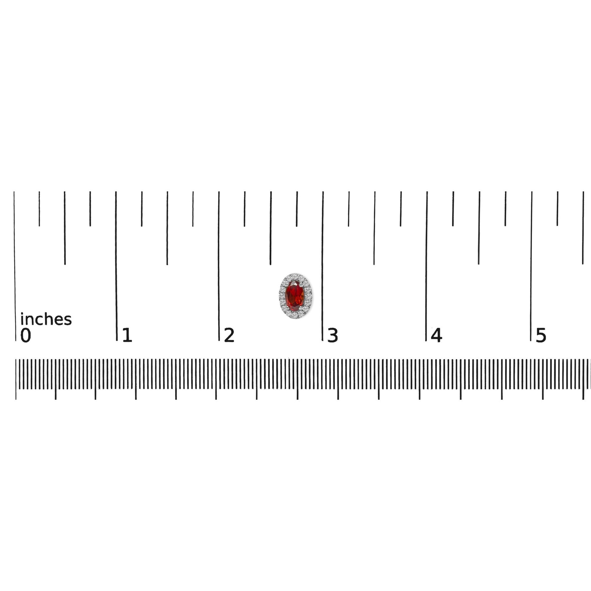White metal earring with a red oval gemstone surrounded by a halo of round white gemstones, shown on a ruler for size reference, front-facing angle.