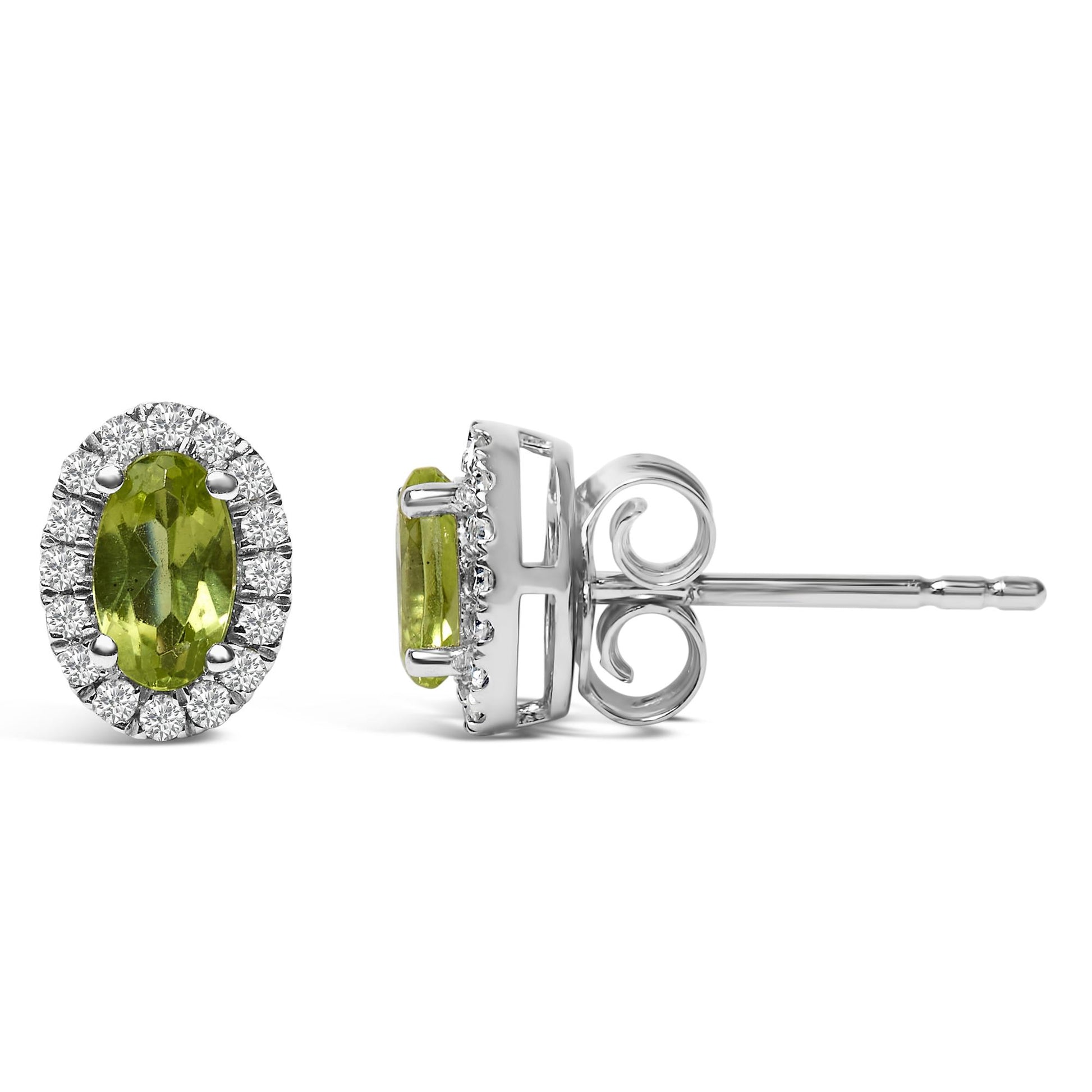 White metal stud earrings with oval green gemstones in four-prong settings, surrounded by a halo of round white gemstones in pave settings, shown from front and side angles on a white background.