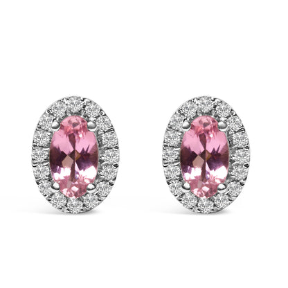 Pair of oval-shaped white metal stud earrings shown from the front, each featuring a central pink oval gemstone surrounded by a halo of round white gemstones in pave setting.