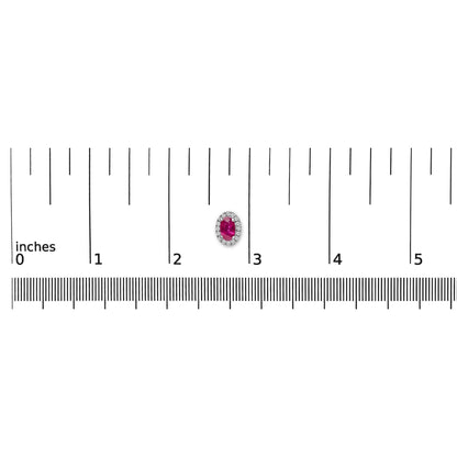 Single white metal earring with an oval red gemstone surrounded by small white gemstones in a pave setting, shown on a ruler for size reference, top-down angle.