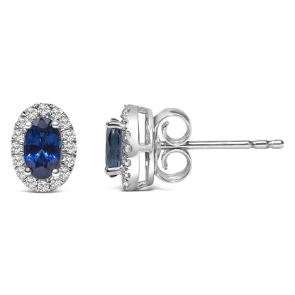 Pair of white stud earrings shown from front and side angles, each featuring an oval blue gemstone surrounded by round white gemstones in a pave setting.