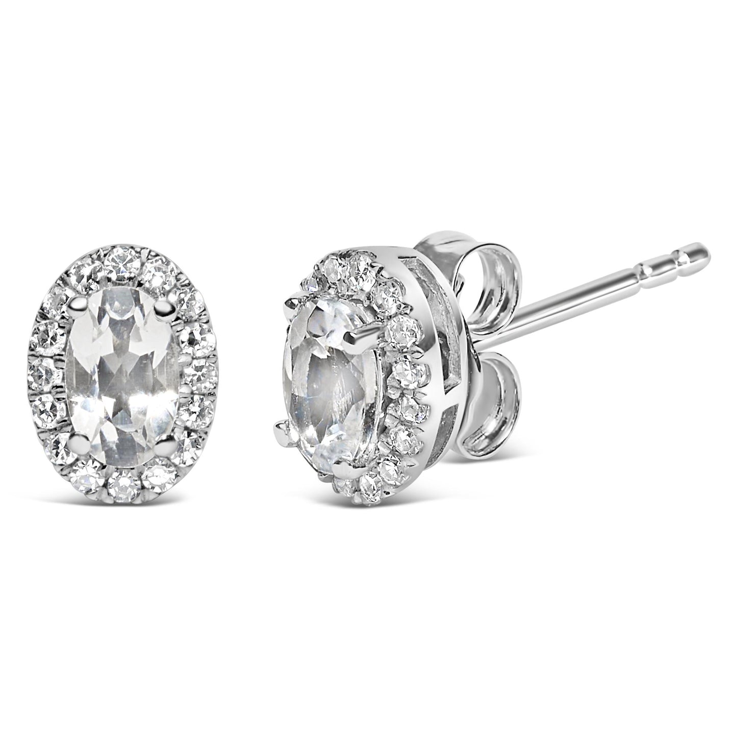 Pair of white metal stud earrings with oval white gemstones surrounded by a halo of round white gemstones, shown in a front and side angled view.