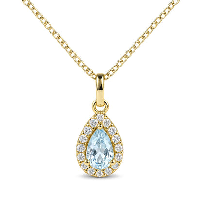Close-up front view of a yellow chain necklace featuring a pear-shaped blue gemstone pendant surrounded by a halo of round white gemstones.