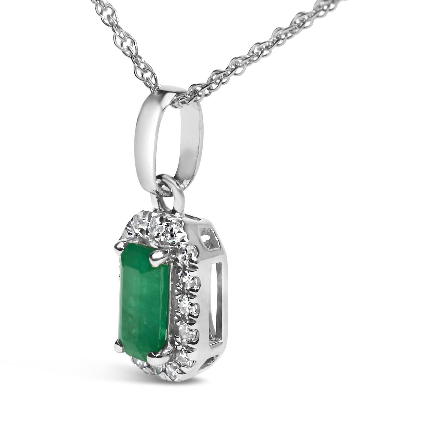 Close-up side angle of white metal necklace pendant featuring a rectangular green gemstone surrounded by small white gemstones in a micro-pave setting.