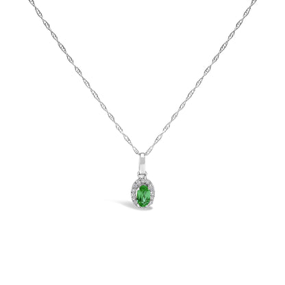 Front view of a white metal necklace with a pendant featuring an oval green gemstone surrounded by small round white gemstones in a micro-pave setting.
