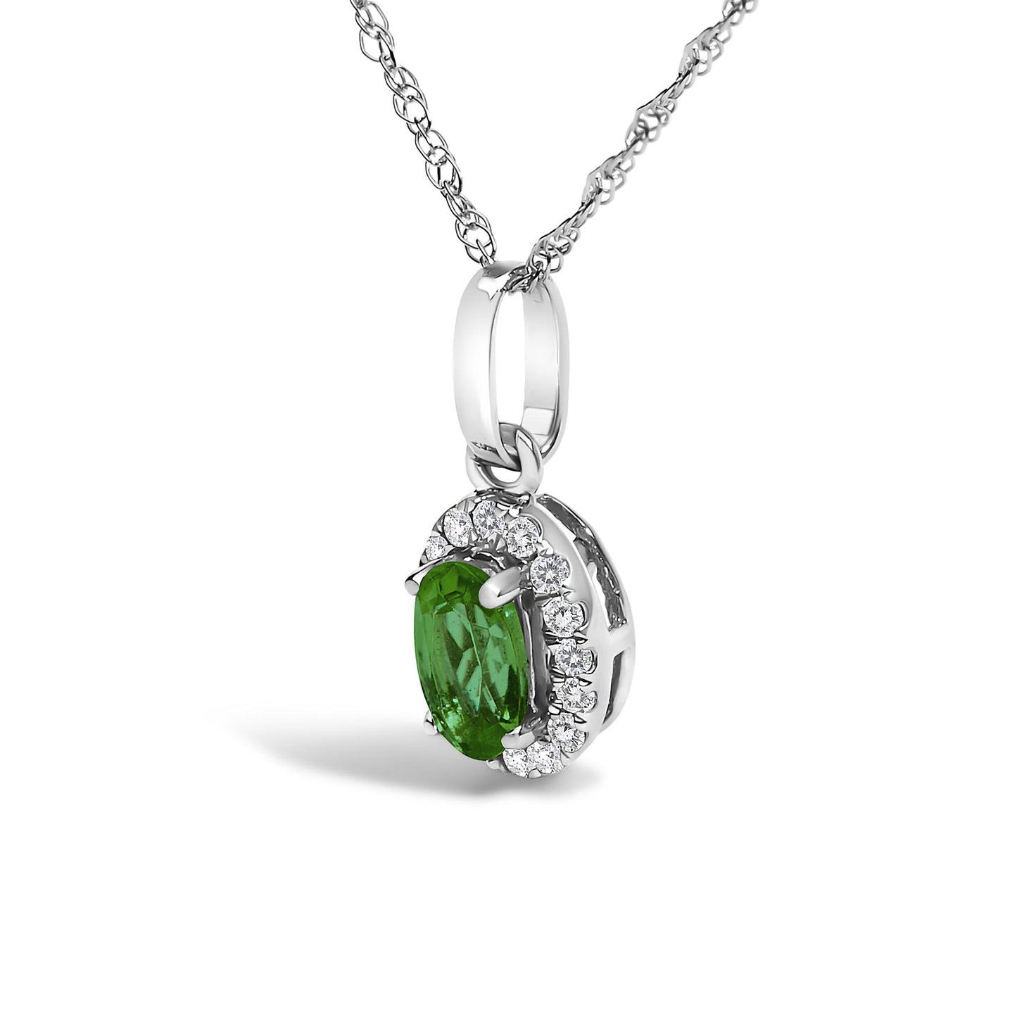Close-up side angle of a white metal necklace pendant featuring a central green oval-shaped gemstone surrounded by white round gemstones in a micro-pave setting.