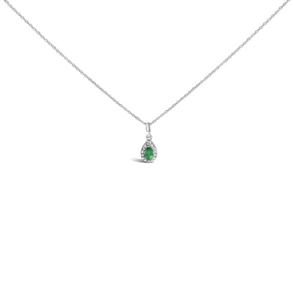 White metal necklace shown from the front with a pear-shaped green gemstone pendant surrounded by small round white gemstones in a micro-pave setting.