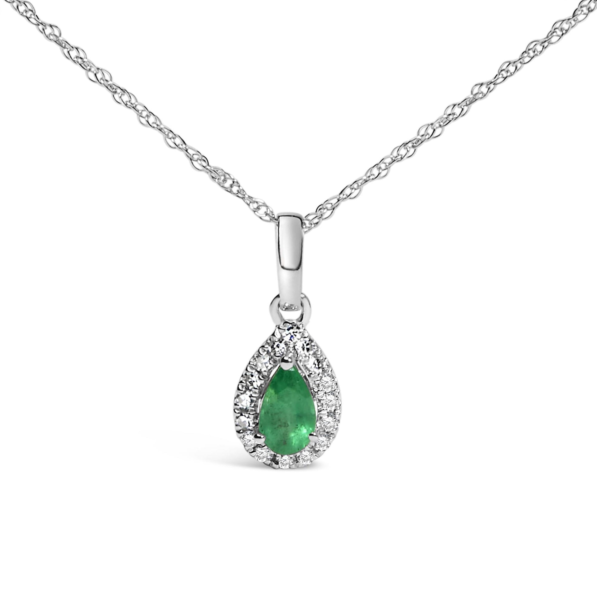 Front-facing close-up of a white metal necklace with a pear-shaped green gemstone pendant surrounded by a halo of small round white gemstones in micro-pave setting.