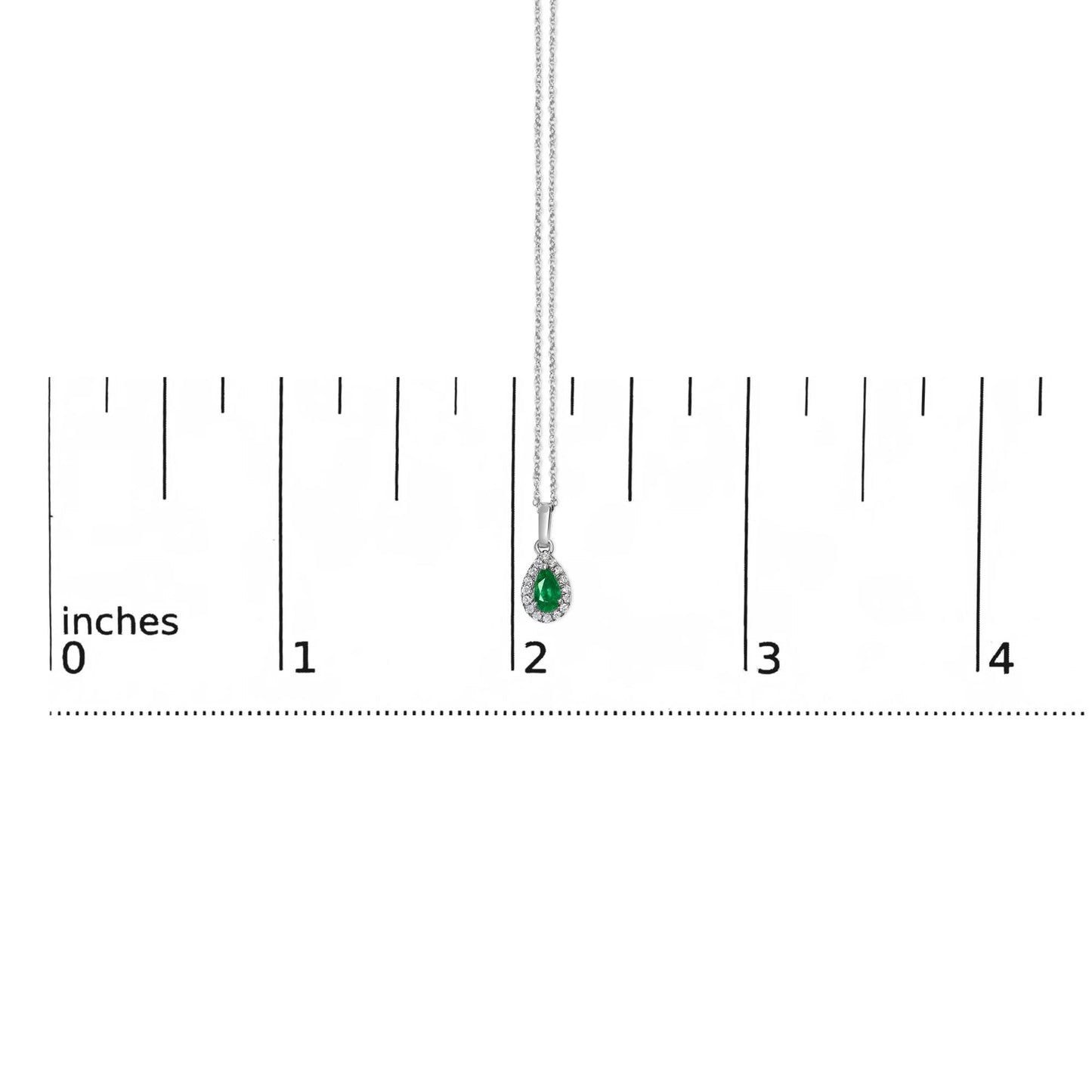Front view of a white metal necklace with a pear-shaped green gemstone pendant surrounded by small round white gemstones, placed on a ruler for size reference.