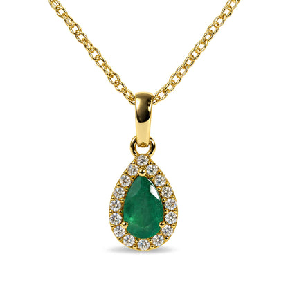 Close-up front view of a yellow necklace with a pear-shaped green gemstone pendant surrounded by a halo of round white gemstones.