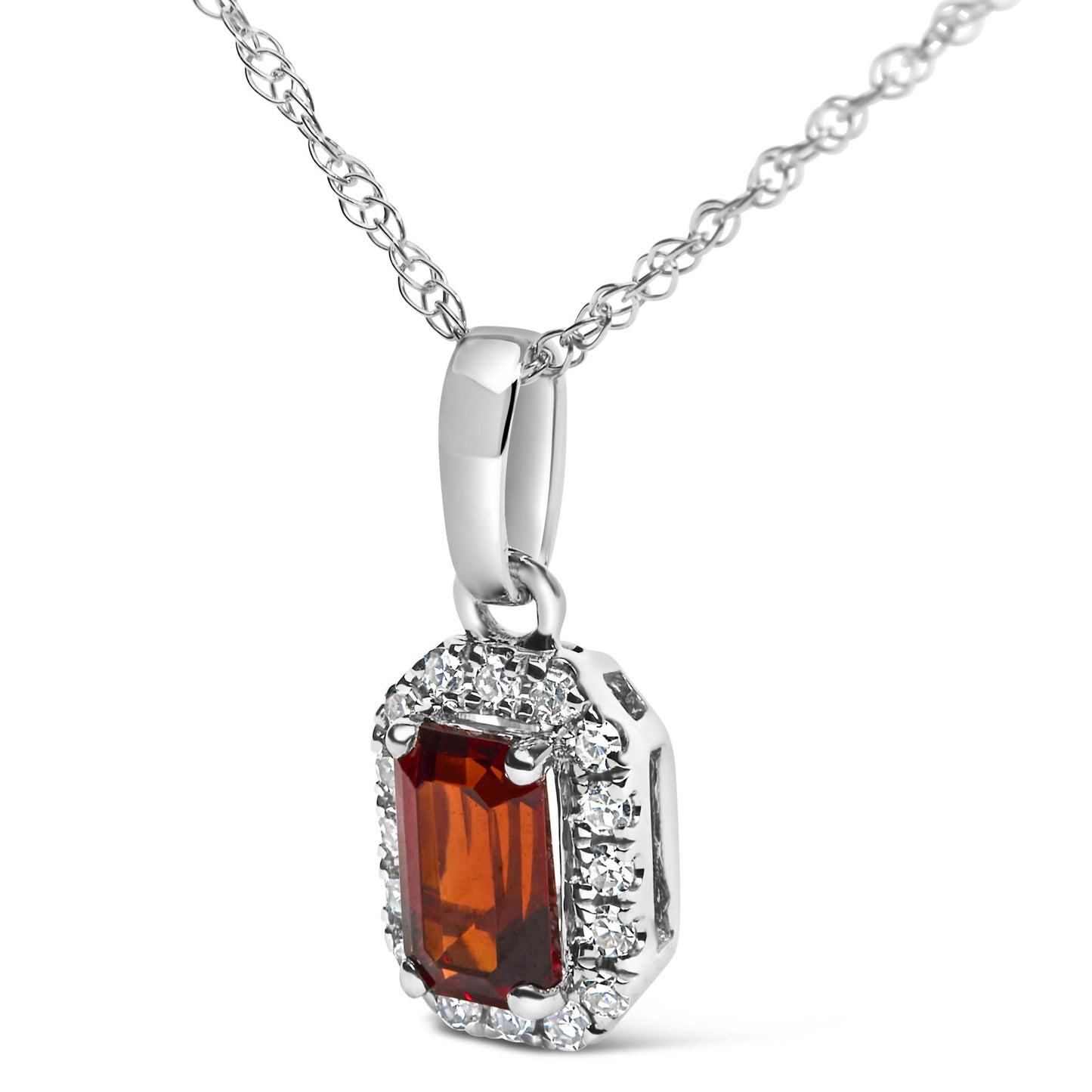 White metal necklace photographed from a slight low angle featuring a rectangular red gemstone in a prong setting surrounded by small round white gemstones in a micro-pave setting.