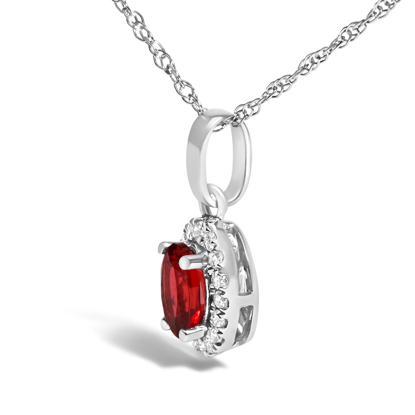 Close-up side angle of a white metal necklace pendant featuring an oval red gemstone surrounded by small round white gemstones in a micro-pave setting.