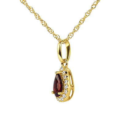 Close-up front view of a yellow metal necklace with an oval link and a pear-shaped red gemstone pendant surrounded by multiple small round white gemstones, shown on a white background.