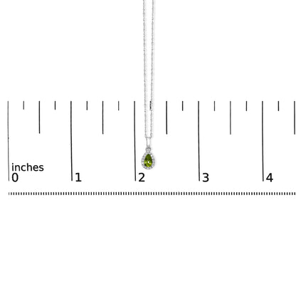 Front view of a white metal necklace with a pear-shaped yellow gemstone pendant surrounded by small round white gemstones, displayed on a ruler for size reference.