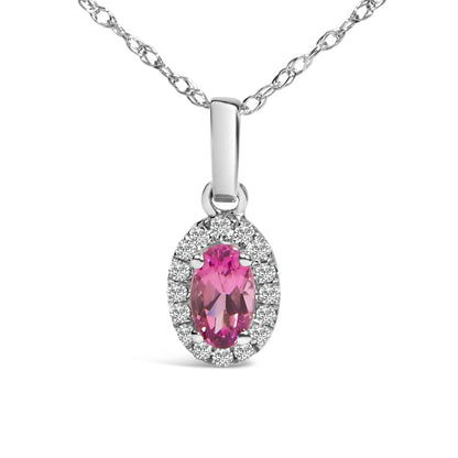Close-up front view of a white metal necklace pendant featuring an oval pink gemstone surrounded by round white gemstones in a micro-pave setting.