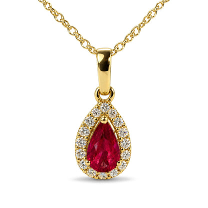 Close-up front view of a yellow metal necklace with a pear-shaped red gemstone pendant surrounded by round white gemstones, shown on a white background.