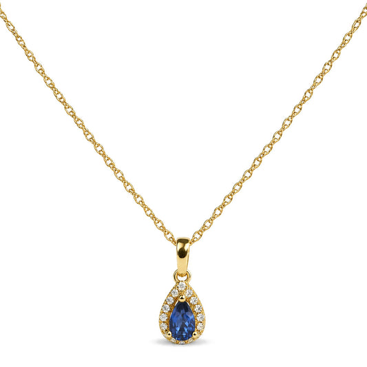 Close-up front view of a yellow necklace chain featuring a pear-shaped blue gemstone pendant surrounded by round white gemstones in prong settings.