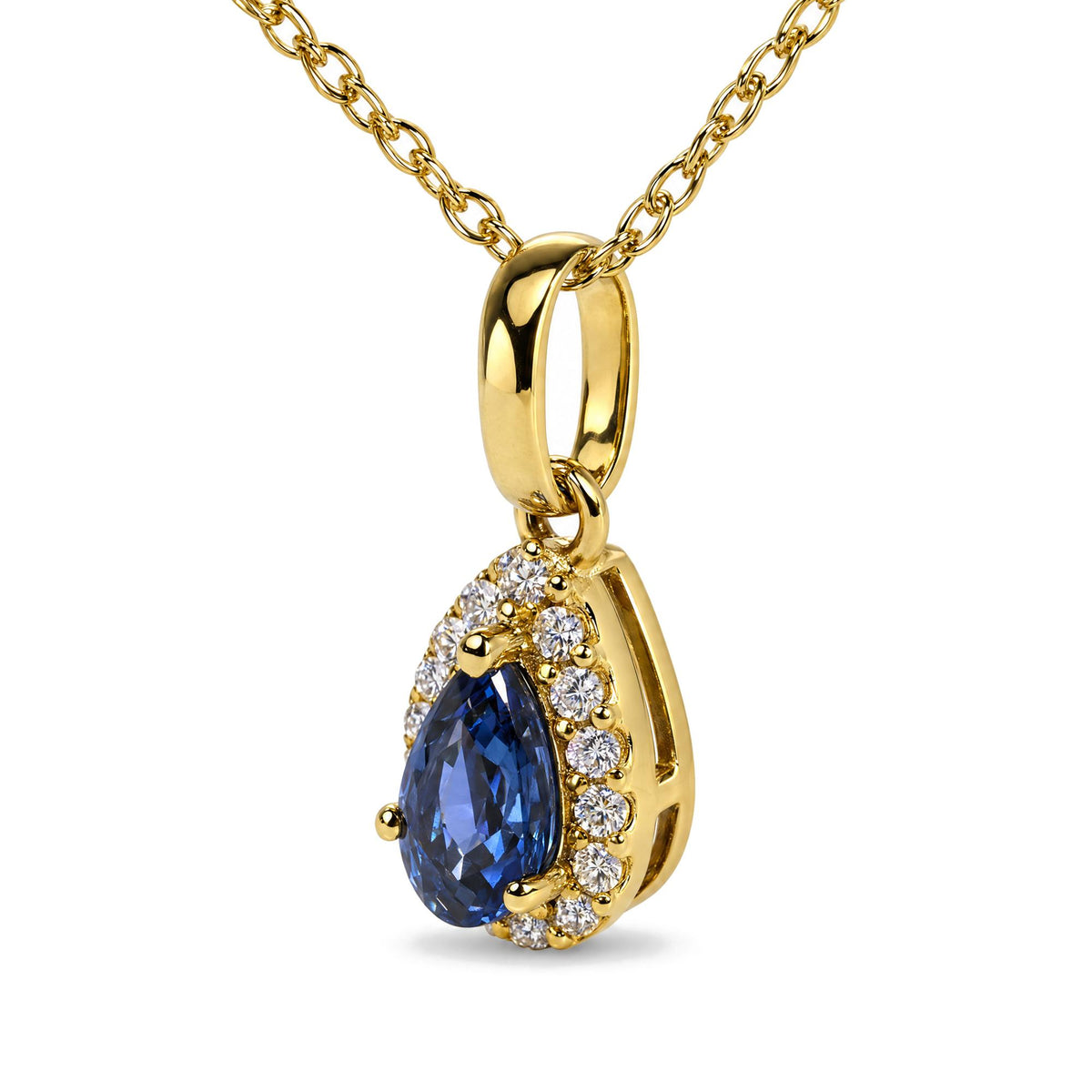 Close-up angled view of a yellow metal necklace chain with a pear-shaped blue gemstone pendant surrounded by white round gemstones in a prong setting.