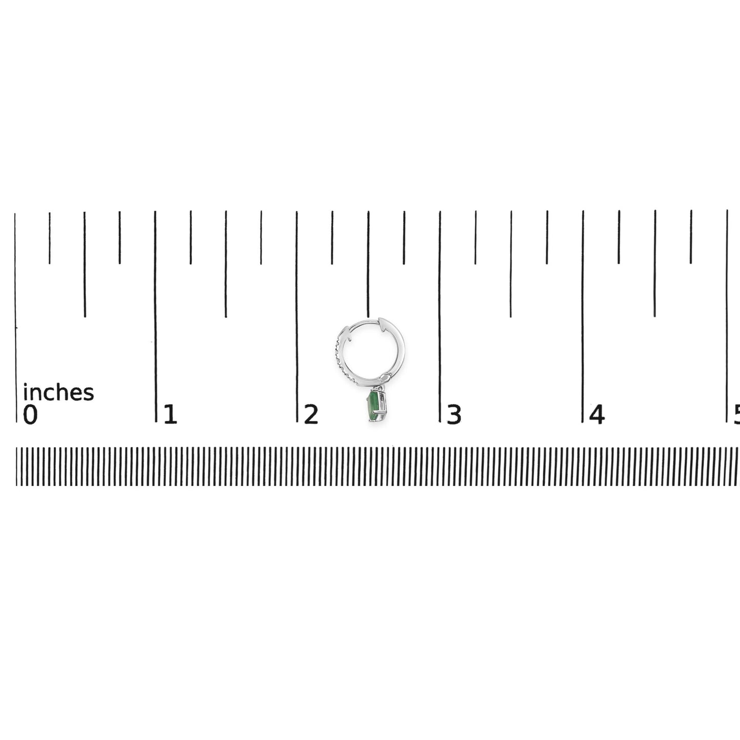 White metal hoop earring with pave-set white round gemstones on the front, featuring a dangling green emerald-shaped gemstone in a prong setting, shown on a ruler scale from a top-down angle.