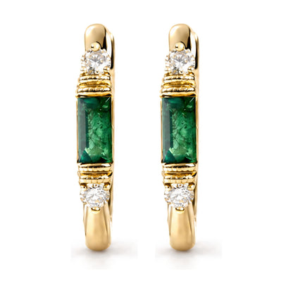 Close-up front view of a pair of yellow metal earrings featuring a round white gemstone in prong setting above a rectangular green gemstone in channel setting.