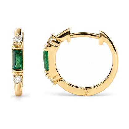 Close-up front and side views of yellow metal hoop earrings featuring two green baguette-shaped gemstones set in a channel setting and four round white gemstones in prong settings.
