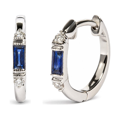 Close-up front and side view of a white metal hoop earring featuring a blue baguette-shaped gemstone in a channel setting, accented with round white gemstones in prong settings near the top.
