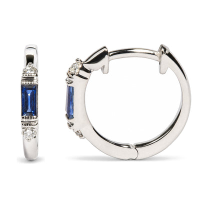 Close-up front and side view of white metal hoop earrings with blue baguette-shaped gemstones in channel settings and round white gemstones in prong settings.