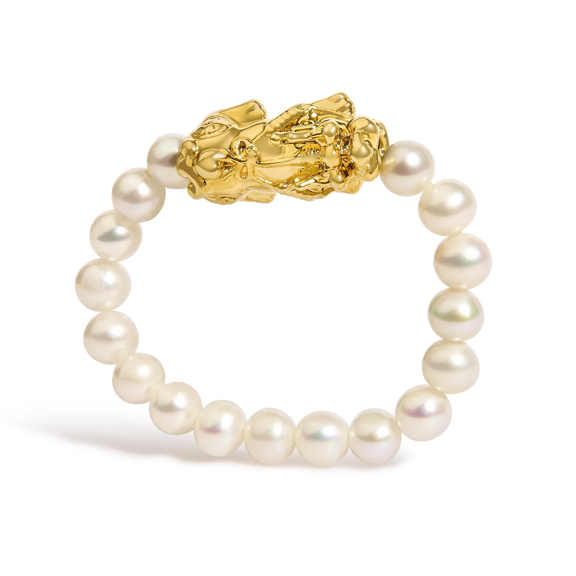 Close-up front angle of a yellow metal ring with detailed sculptural design, surrounded by a string of white round pearls, shown against a white background.