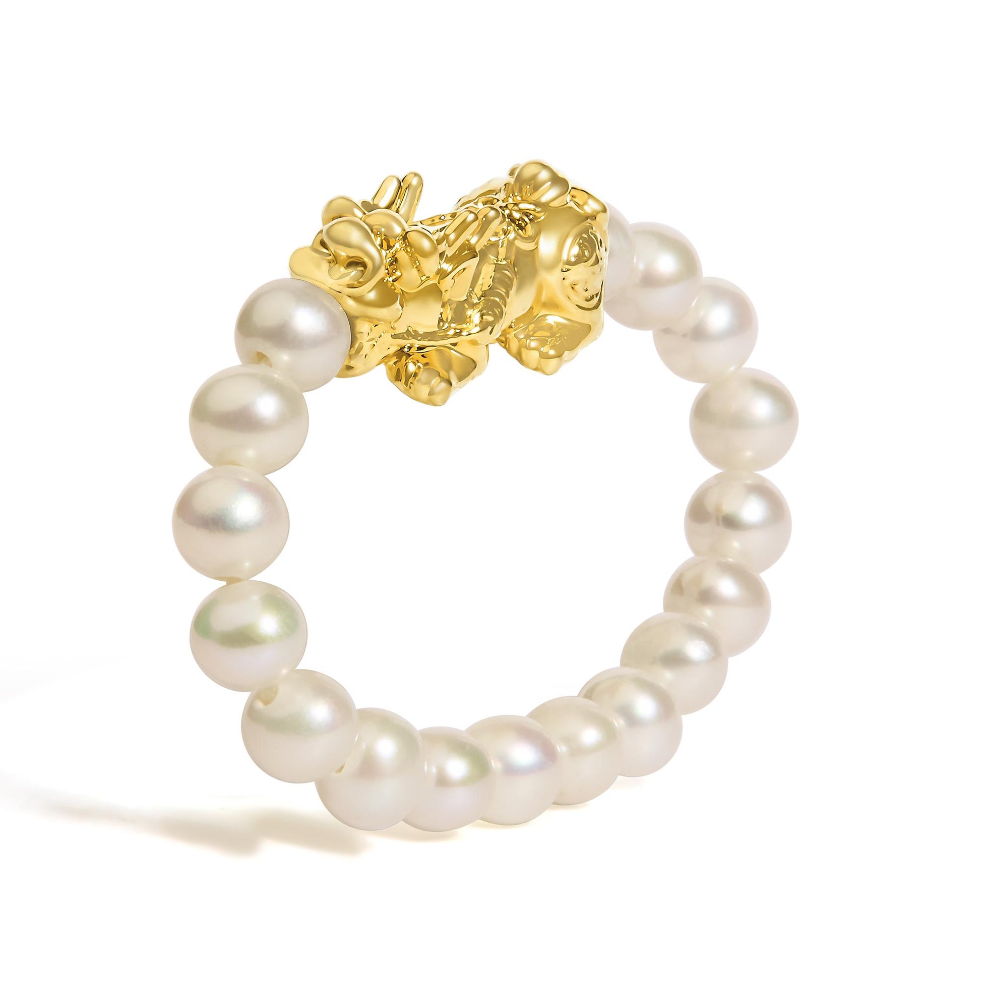Close-up of a yellow metal ring with a decorative cluster design, shown from the top angle, featuring round white gemstones arranged around the band.