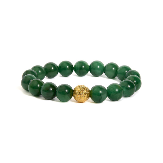 Close-up front angle of a bracelet composed of round green gemstones with a single intricate yellow metal bead in the center, shown on a white background.