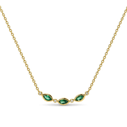 Close-up front view of a yellow metal necklace with three green marquise-shaped gemstones and four round white gemstones set in bezels, shown on a white background.