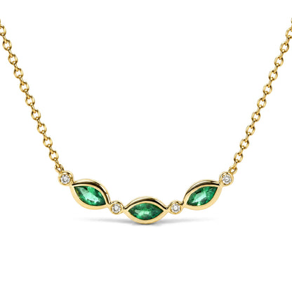 Close-up front view of a yellow metal necklace with a curved design featuring marquise-shaped green gemstones and round white gemstones set in bezels.