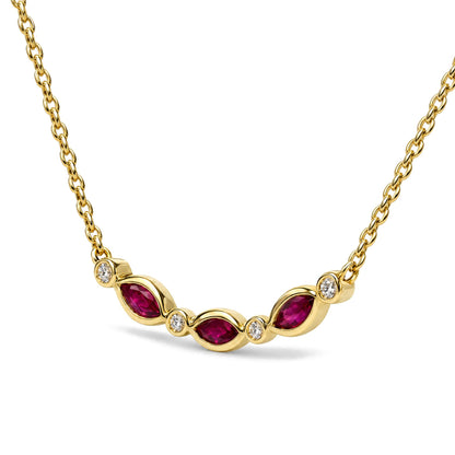 Close-up front angle of a yellow metal necklace with alternating marquise-shaped red gemstones in prong settings and round white gemstones in bezel settings, shown on a white background.