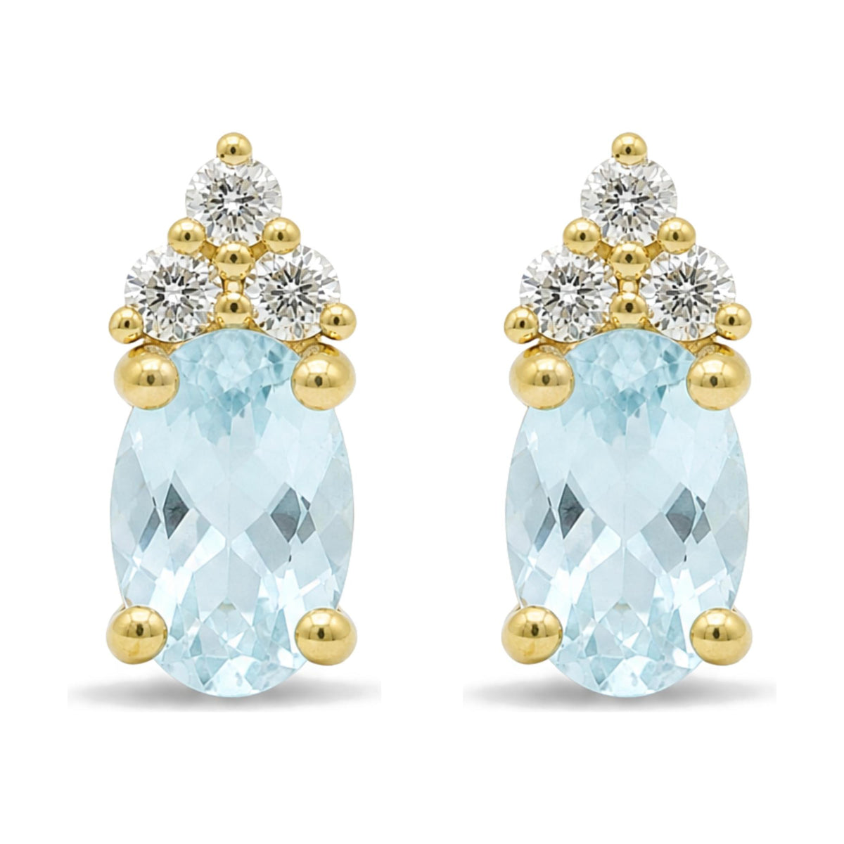Close-up front view of yellow metal earrings featuring an oval blue gemstone with three round white gemstones arranged above it in a triangular pattern, all in prong settings.
