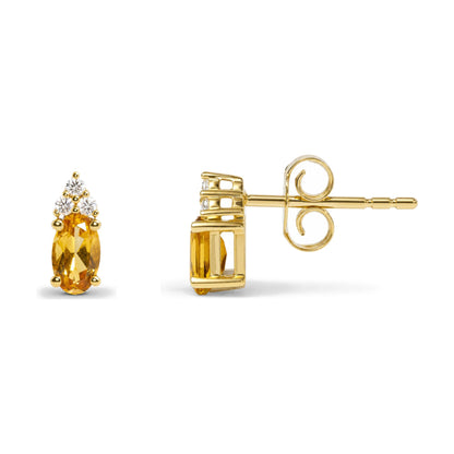 Close-up side and front views of a yellow metal earring featuring an oval yellow gemstone and round white gemstones in prong settings.