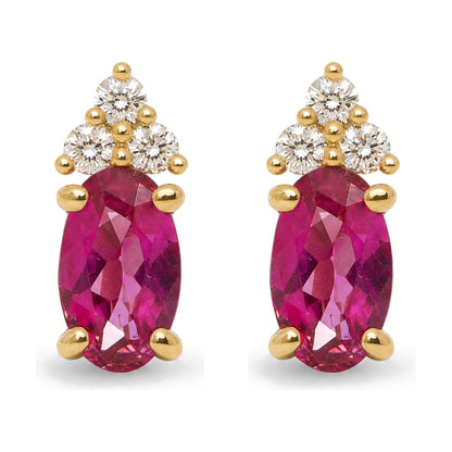 Close-up front view of a pair of yellow metal earrings featuring oval-shaped pink gemstones held by prong settings, accented with clusters of round white gemstones above.