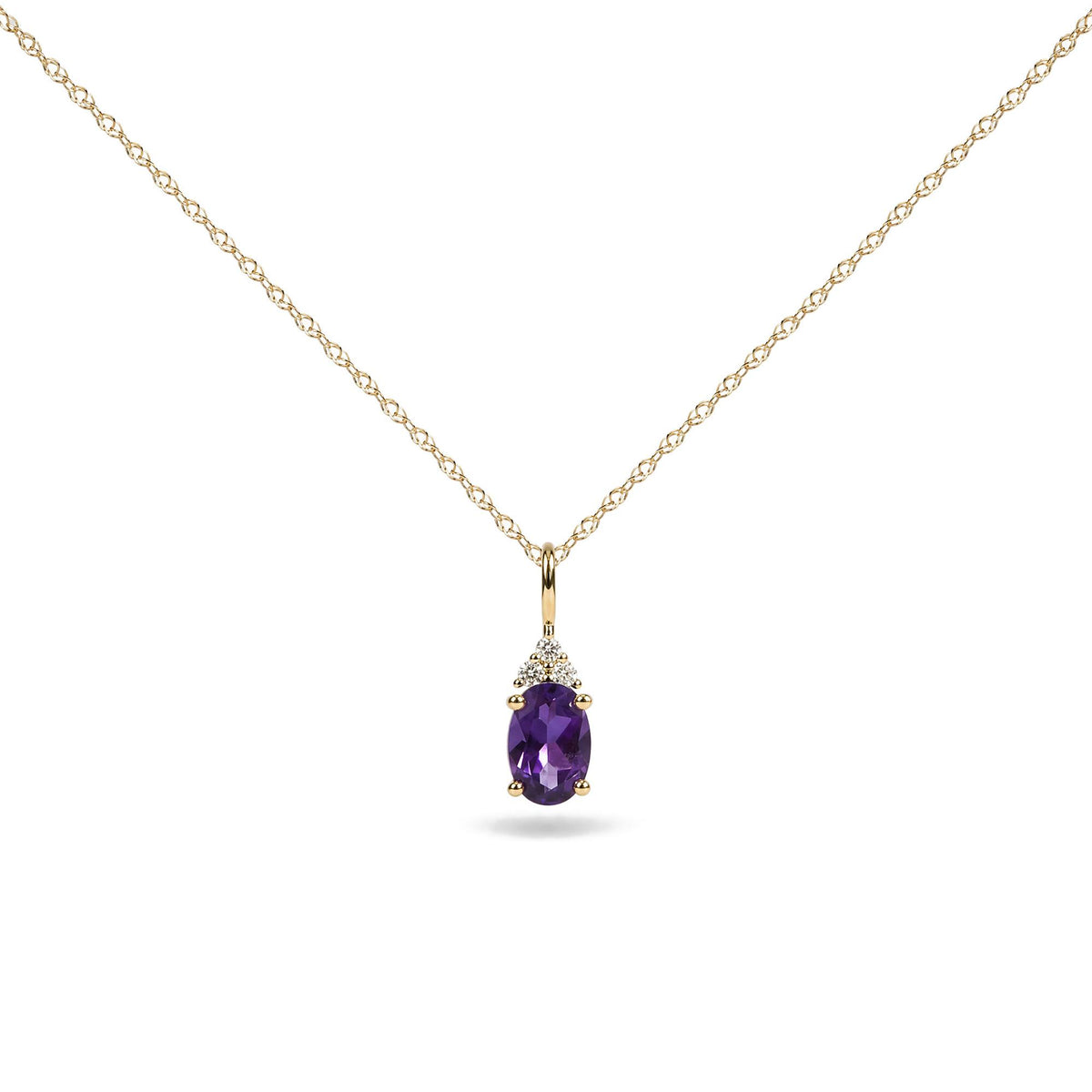 Close-up front view of a yellow metal necklace with an oval purple gemstone pendant, accented by three round white gemstones above it, shown on a white background.